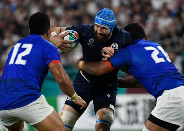 Scotland's No 8 Blade Thomson is tackled by Samoa's Josh Tyrell and Henry Taefu. Picture: AFP/Getty Images