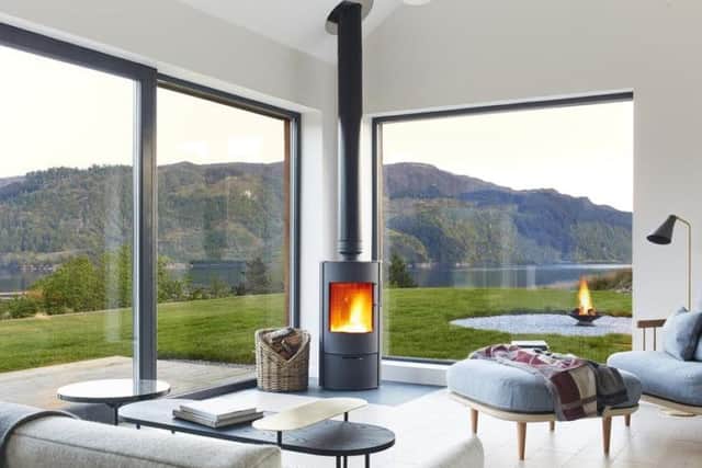 The living room has a modern wood burning stove which keeps the space warm on cold days.