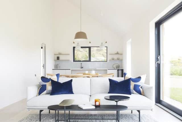 The open plan living space includes a small, modern kitchen.