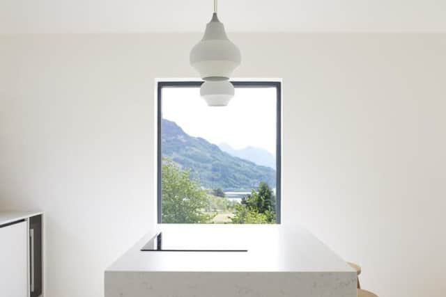 The sleek kitchen also enjoys views of the surrounding countryside.