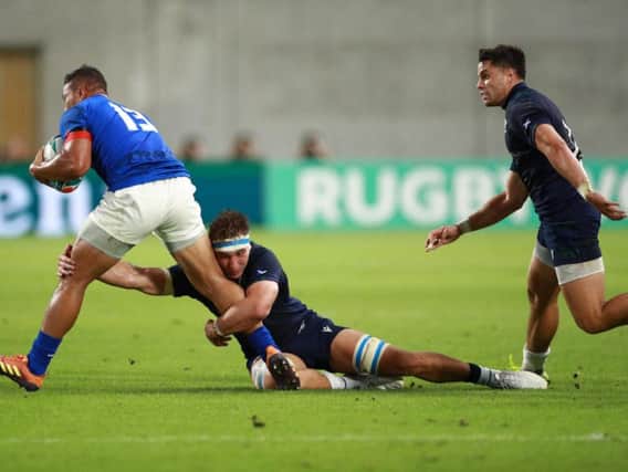 Scotland star man Jamie Ritchie puts in a tackle on Samoa centre Alapati Leiua in Kobe on Monday. Picture: Getty Images