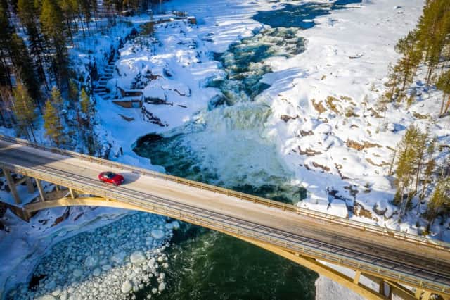 Navigating an icy bridge across a frozen river, Mazda Arctic Circle Drive.
