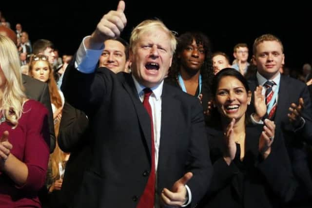 Prime Minister Boris Johnson and Home Secretary Priti Patel at the Conservative Party conference in Manchester