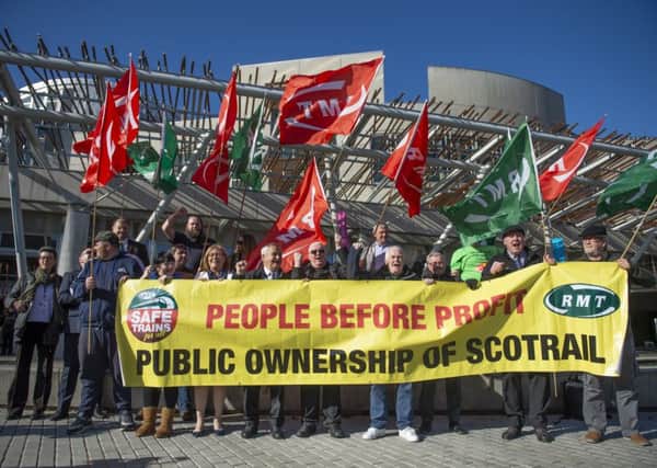 Members of the RMT union demonstrating outside the Scottish Parliament in Edinburgh, calling for the immediate termination of Abellio ScotRail's contract and for the essential public service to be brought  back into public ownership. Picture: James Chapelard/RMT