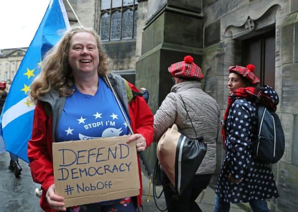 A protester outside the Court of Session in Edinburgh. Picture: Andrew Milligan/PA Wire