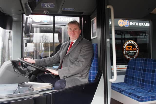 McGill's board director Sandy Easdale at the wheel of one the operator's new fleet. Picture: Contributed