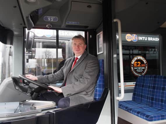 McGill's board director Sandy Easdale at the wheel of one the operator's new fleet. Picture: Contributed
