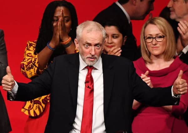 Jeremy Corbyn acknowledges the cheers of Labour party members. Photograph: Leon Neal/Getty