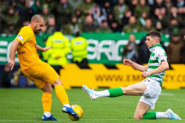 Ryan Christie goes in with a straight-leg, high-footed lunge on Scott Robinson. Picture: SNS