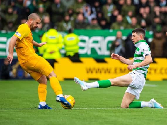 Ryan Christie goes in with a straight-leg, high-footed lunge on Scott Robinson. Picture: SNS