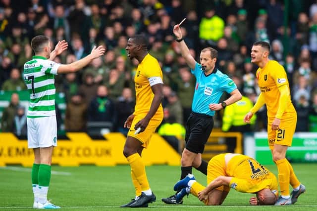 Ryan Christie is shown a red card by referee Willie Collum. Picture: SNS