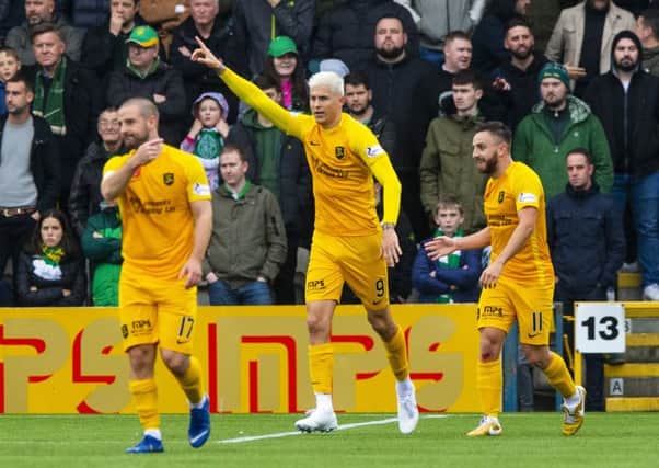 Lyndon Dykes, celebrating his goal against Celtic, is qualified to play for Scotland. Picture: SNS