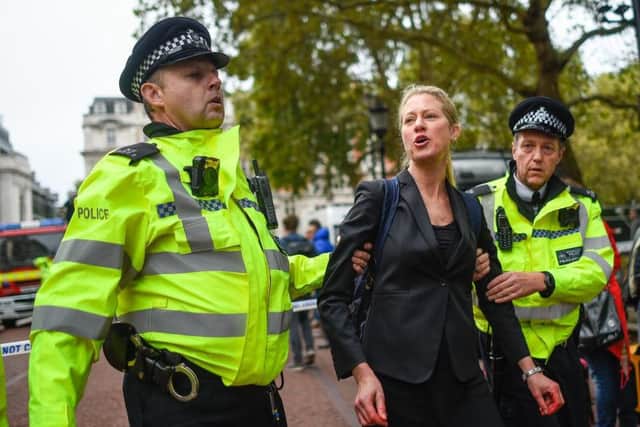 A climate change activist is arrested outside the Treasury building on October 3, 2019 in London. Picture: Getty Images