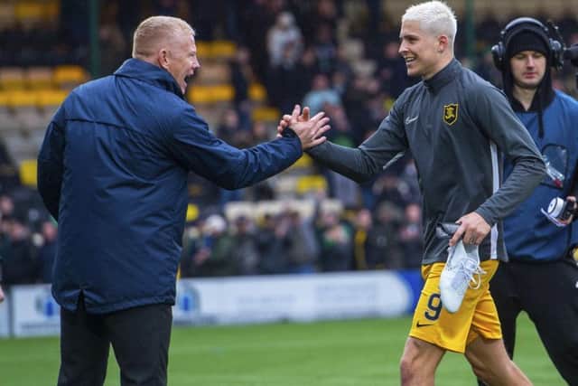Livingston manager Gary Holt congratulates Lyndon Dykes as he leaves the field on Sunday. Picture: SNS.