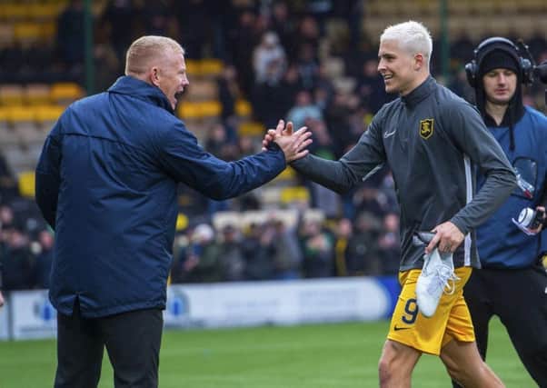 Livingston manager Gary Holt congratulates Lyndon Dykes as he leaves the field on Sunday. Picture: SNS.