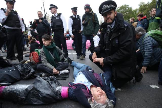 Protesters from Extinction Rebellion (XR) block a road in Westminster. Picture: Yui Mok/PA Wire