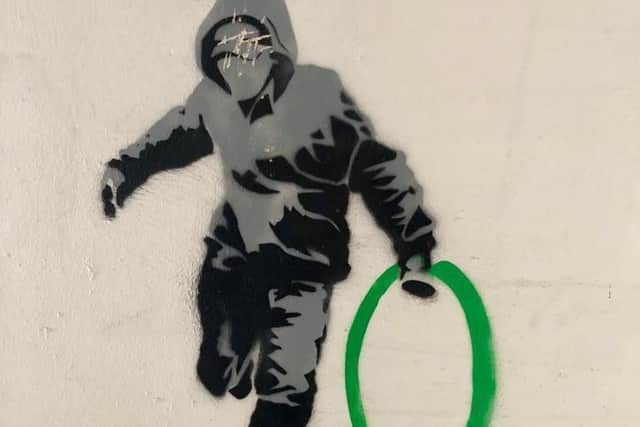 The hooded figure has appeared on a close wall on Bernard Street