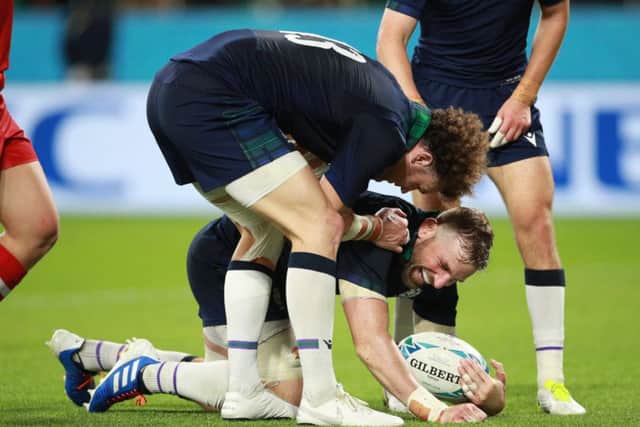John Barclay is congratulated by Duncan Taylor after scoring Scotlands eighth try during the victory over Russia. Picture: Adam Pretty/Getty