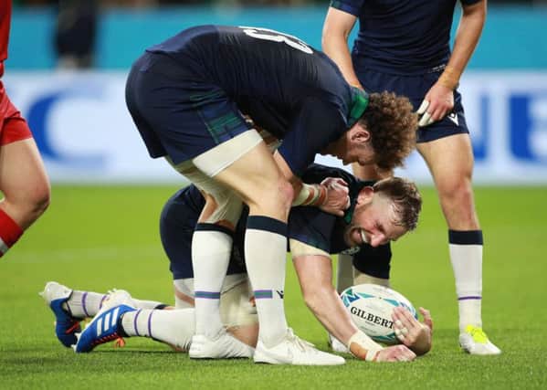 John Barclay is congratulated by Duncan Taylor after scoring Scotlands eighth try during the victory over Russia. Picture: Adam Pretty/Getty