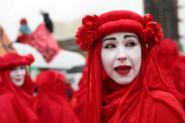 Climate change activists from the group Extinction Rebellion, dressed in red costume, demonstrate in London (Picture: Isabel Infantes/AFP/Getty Images)