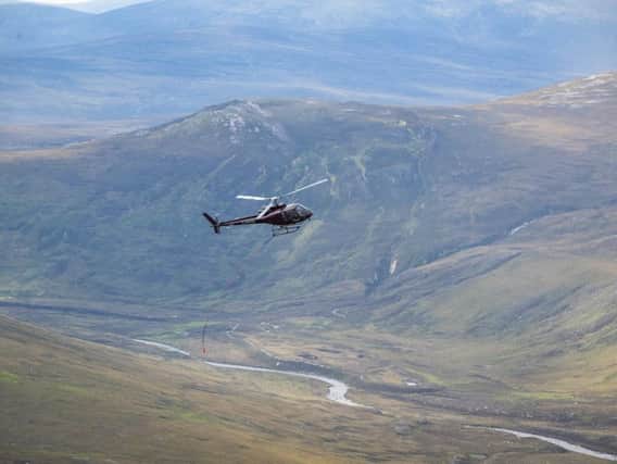 A helicopter delivers material for footpath repairs in Torridon. PIC: NTS.
