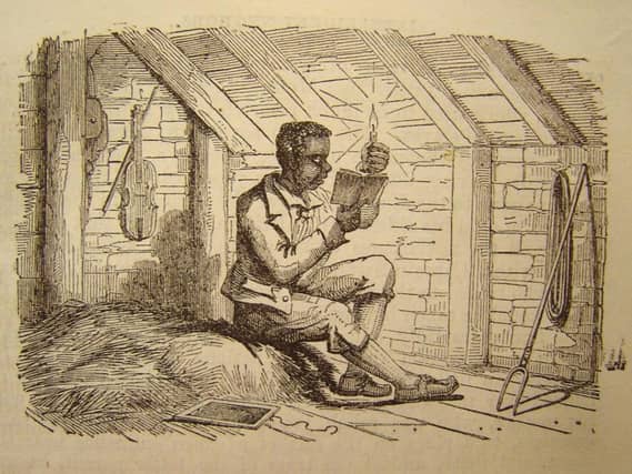 Tom Jenkins studying by candlelight. ( The Johnnie Armstrong Gallery).