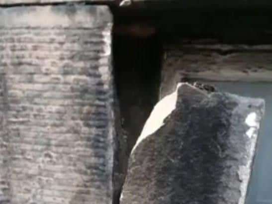 A section of stone window surround comes off a building in George Street