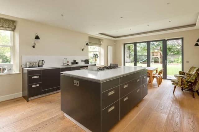 The smart contemporary kitchen has a large island unit.