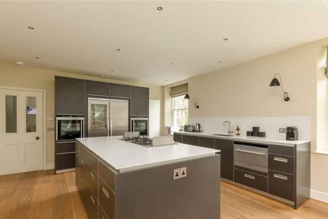 The kitchen has quality fixtures and fittings, including a wine fridge.