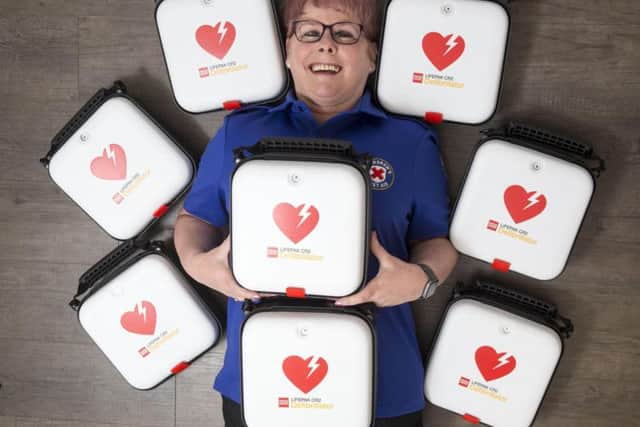 Volunteer first aider Jacine Clark with a deilvery of defibrillators for St Andrews First Aid.