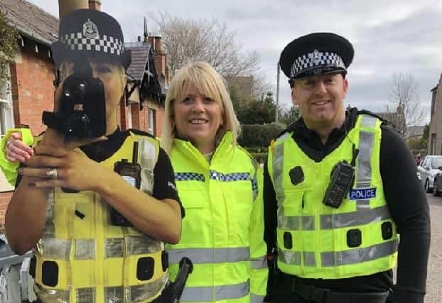 Life-size pictures of police officers have been deployed in Dundee and Edinburgh to try to cut speeding