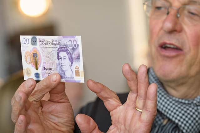 Artist Antony Gormley observes the new 20 pound note