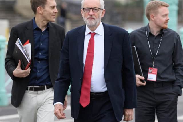 Labour leader Jeremy Corbyn flanked by political aide Seumas Milne (left) and Labour activist Andrew Fisher (right)