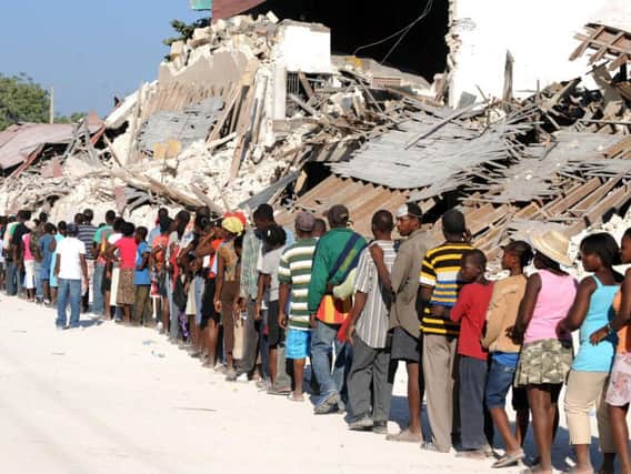 Haitians queue at a UN aid distribution site. Picture: Getty