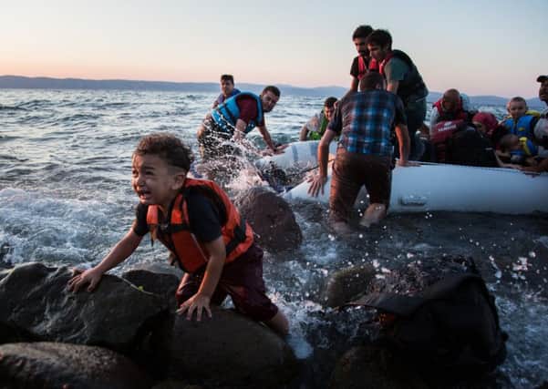 Think Odysseus was cruel? Today many are indifferent to the struggles of desperate people on the wine-dark sea, like this group of Syrian refugees arriving on the island of Lesbos after traveling in an inflatable raft from Turkey. (Picture:: UNHCR/Andrew McConnell)