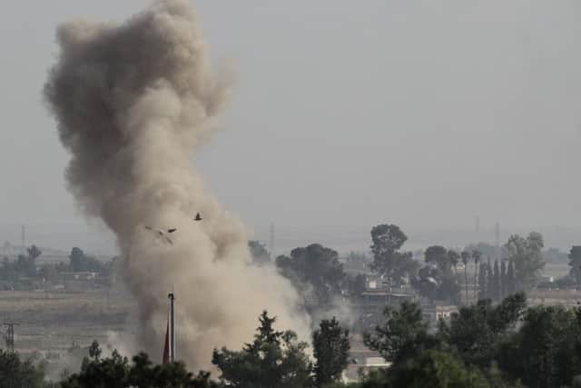 Smoke rises over the Syrian town of Ras al-Ain as Turkey launches an offensive against Kurdish forces after getting the tacit approval of Donald Trump (Picture: Burak Kara/Getty Images)