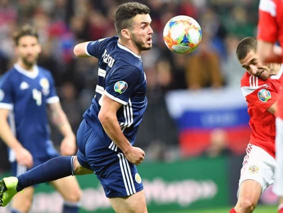 John McGinn battles for possession during the 4-0 loss in Russia.