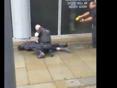 Screen capture from video showing a man being held by police with a Taser outside the Arndale centre. Picture: John Greenhalgh Twitter @JohnGre07881147