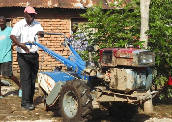 Howard Msukwa, chair of the rice farmers' association, trying out a new rotavator, supplied by Paisley-based fair-trade company JTS (Picture: JTS).