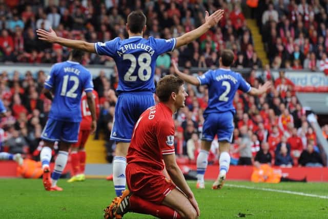 A dejected Steven Gerrard sinks to his knees as Chelsea celebrate their 2-0 victory at Anfield in 2014, a match which had been billed as the league  title decider. Gerrards slip had led to the Blues crucial opening goal. Picture: Liverpool FC via Getty