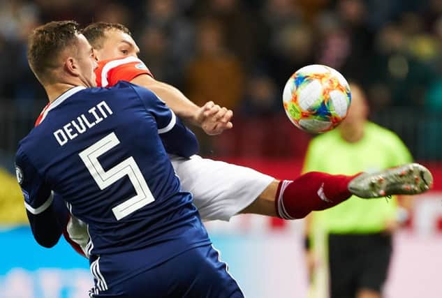 Scotland defender Mikey Devlin tries to get to grips with Russia striker Artem Dzyuba in Moscow. Picture: Oleg Nikishin/Getty