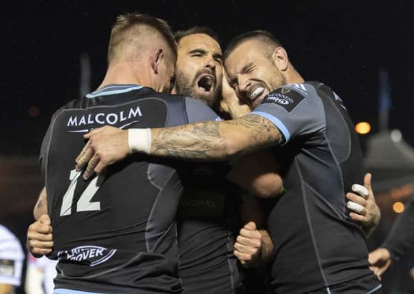 Nick Frisby is mobbed by team-mates after scoring Glasgow's second try against Cardiff. Picture: Alan Harvey/SNS