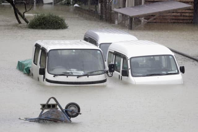 Cars submerged in water in Ise, central Japan, after it was hit by Typhoon Hagibis. Picture: Kyodo News via AP