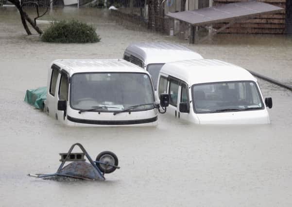 Cars submerged in water in Ise, central Japan, after it was hit by Typhoon Hagibis. Picture: Kyodo News via AP