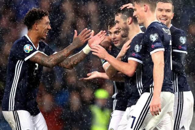 John McGinn is congratulated after netting his, and Scotland's, third