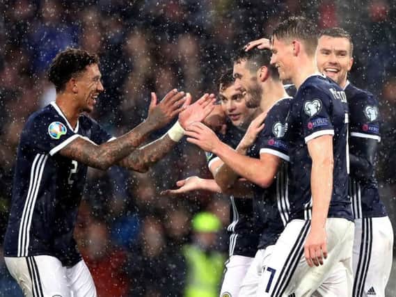 John McGinn is congratulated after netting his, and Scotland's, third