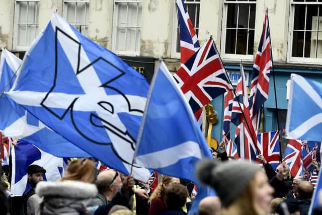 Nationalists and unionists, carrying the Saltire and Union Jack respectively, meet. (Picture: Lisa Ferguson)