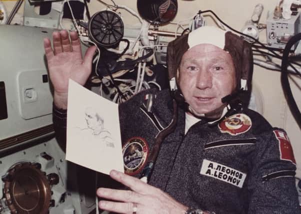 Alexei Leonov holds up his drawing of opposite number Thomas P Stafford to the camera on the Apollo-Soyuz mission. Picture: Space Frontiers/Getty