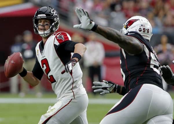 Atlanta Falcons quarterback Matt Ryan scrambles to avoid Arizona Cardinals linebacker Terrell Suggs. Picture: Rick Scuteri/AP