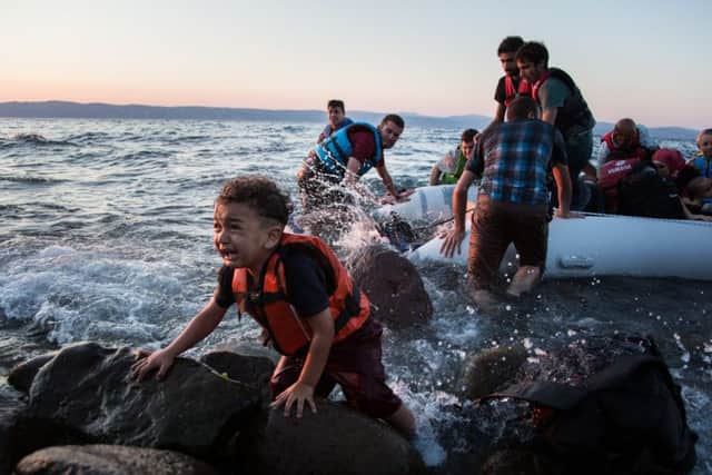 A group of Syrian refugees arrive on the island of Lesbos after traveling in an inflatable raft from Turkey, near Skala Sykaminias, Greece. Credit: UNHCR/Andrew McConnell.